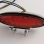 Feu arrière rouge ovale à LEDS avec support métal noir